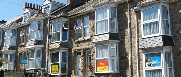 Row of residential properties with political signs in the windows