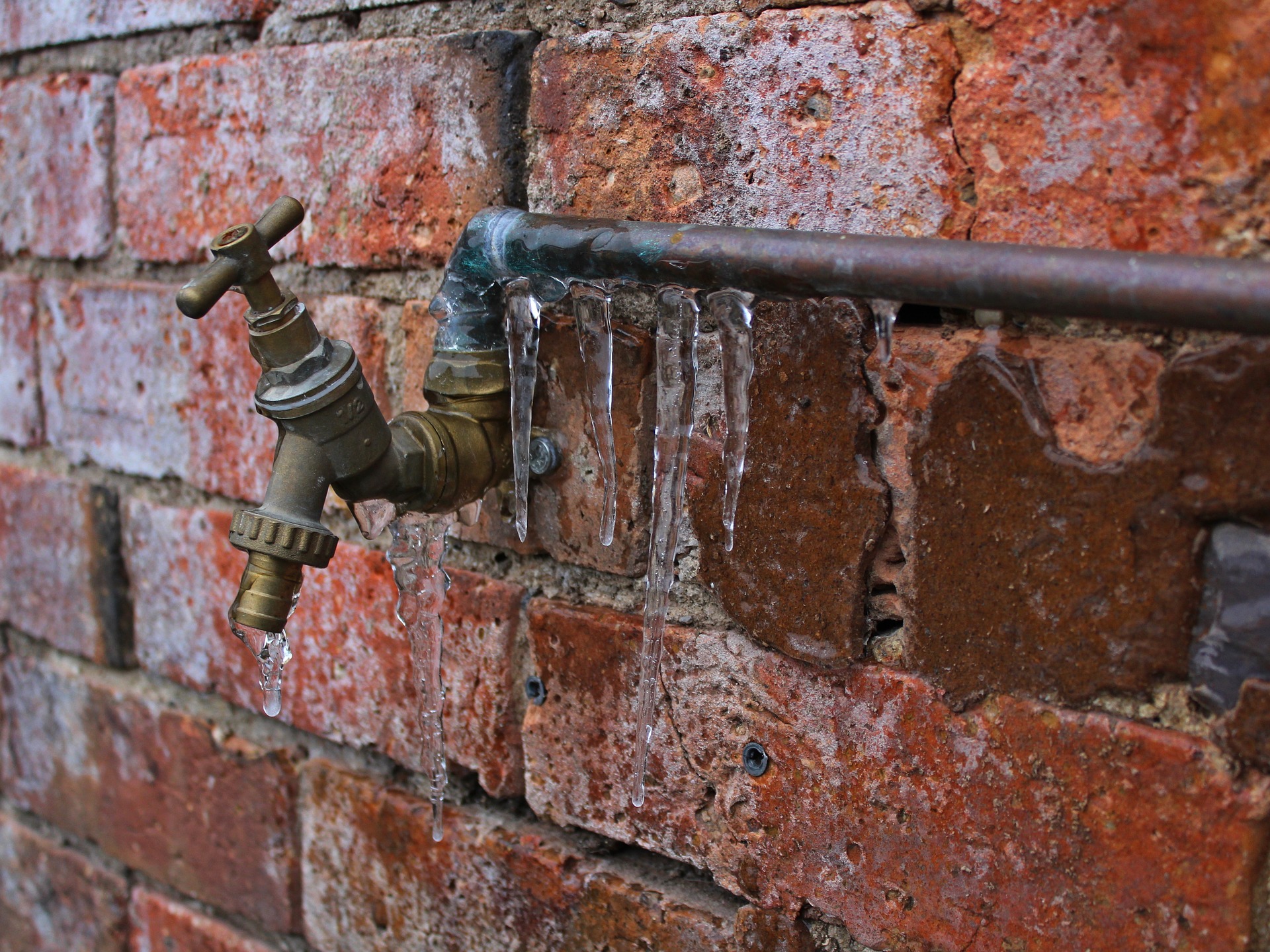 Frozen outside pipe and tap on residential brick property