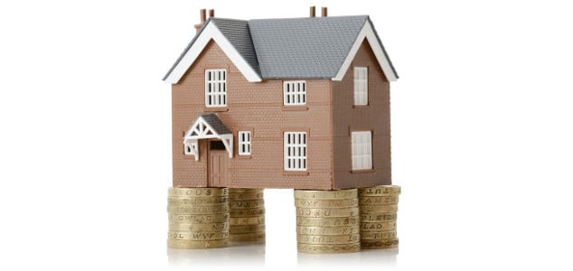 Residential property sitting on stacks of coins