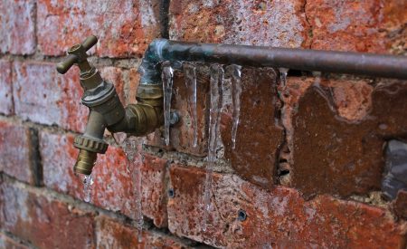 Frozen outside pipe and tap on residential brick property