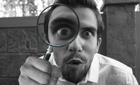 Man investigating leasehold property matters with a magnifying glass