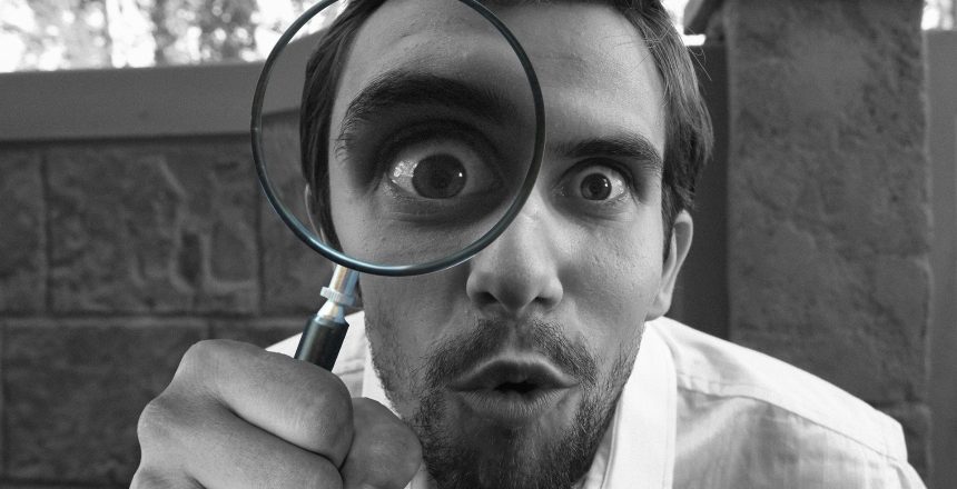 Man investigating leasehold property matters with a magnifying glass