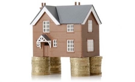 Residential property sitting on stacks of coins