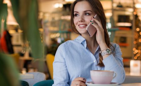 Young lady on the phone with a coffee