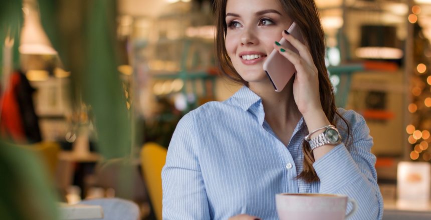 Young lady on the phone with a coffee