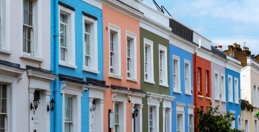 A row of colourful residential properties containing leasehold flats