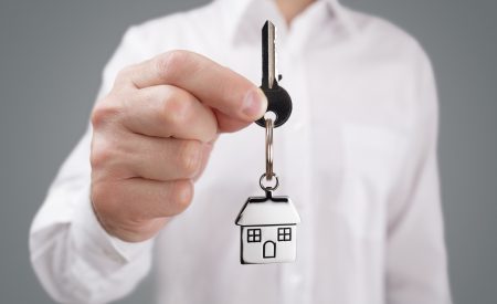 Landlord holding a key with a property keyring