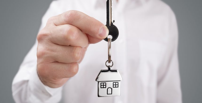 Landlord holding a key with a property keyring