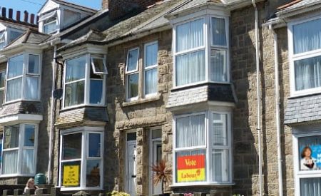 Row of residential properties with political signs in the windows