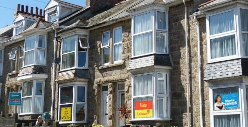 Row of residential properties with political signs in the windows